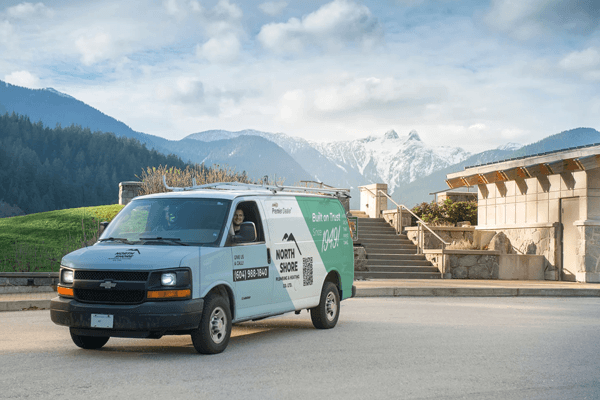North Shore Plumbing & Heating service van with mountains behind it.