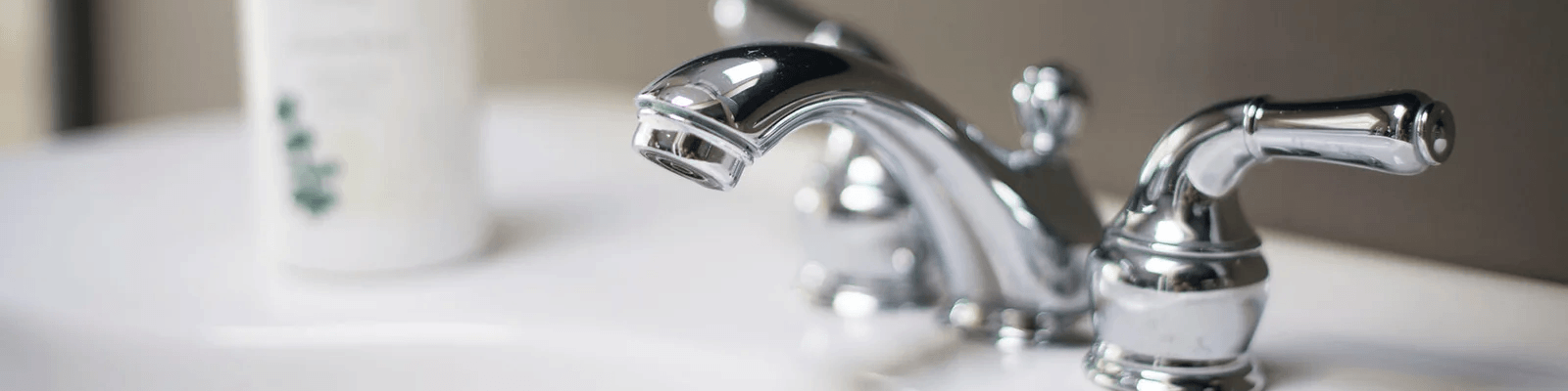 Chrome bathroom faucet installed over a white sink in a North Shore home.